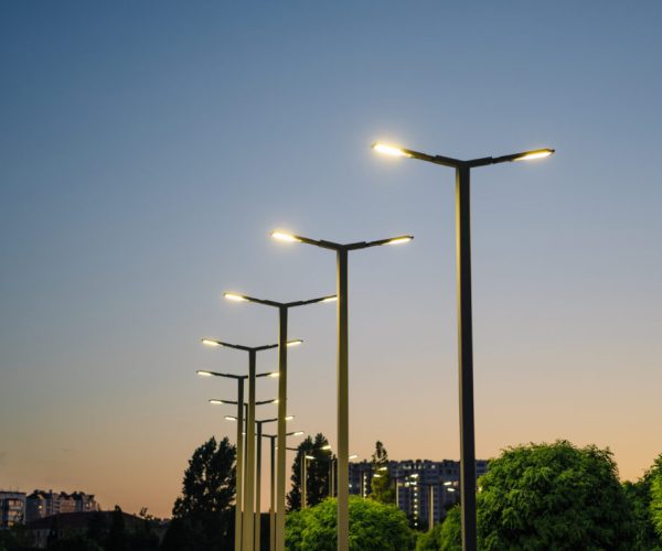 A modern street LED lighting pole. Urban electro-energy technologies. A row of street lights against the night sky.